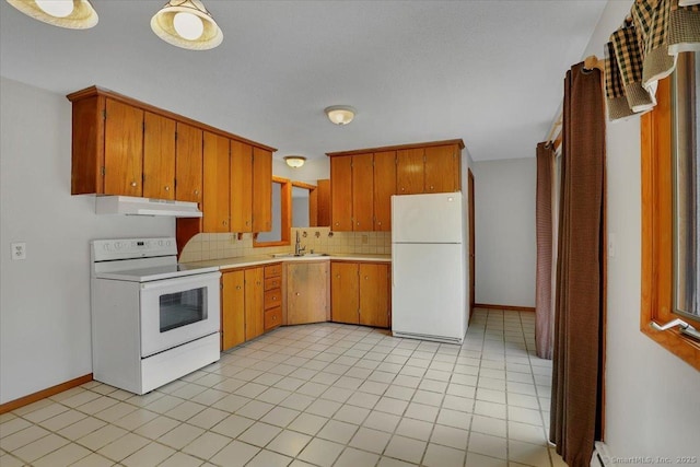 kitchen featuring white appliances, decorative backsplash, light countertops, under cabinet range hood, and a sink