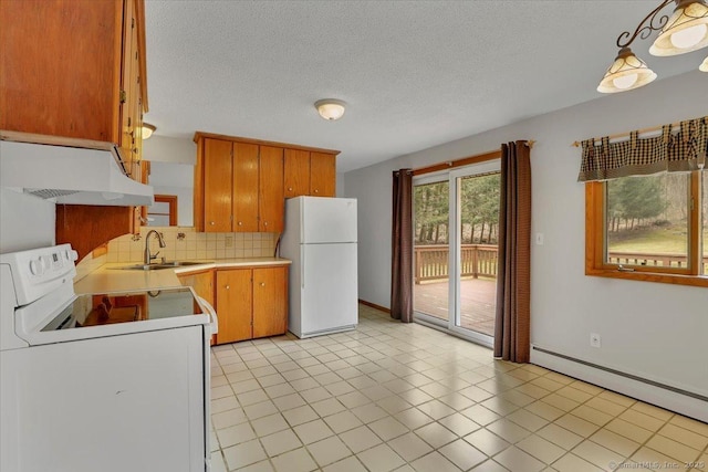 kitchen with a baseboard radiator, light countertops, a sink, white appliances, and under cabinet range hood