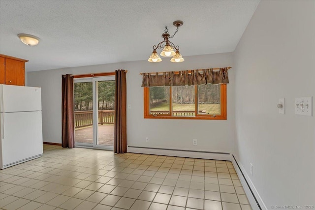 unfurnished dining area featuring a baseboard heating unit, a textured ceiling, baseboards, and light tile patterned floors