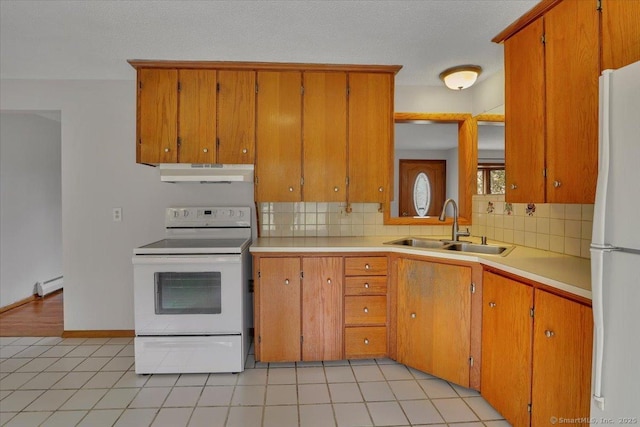 kitchen with under cabinet range hood, a baseboard heating unit, white appliances, a sink, and light countertops