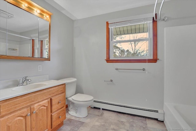 bathroom featuring toilet, a washtub, walk in shower, vanity, and a baseboard heating unit