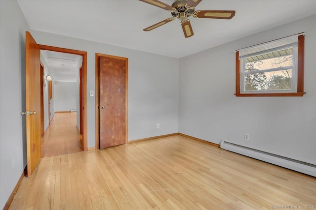 unfurnished bedroom featuring light wood-type flooring, baseboards, ceiling fan, and baseboard heating