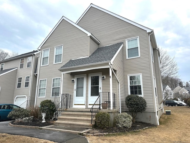 multi unit property featuring a shingled roof