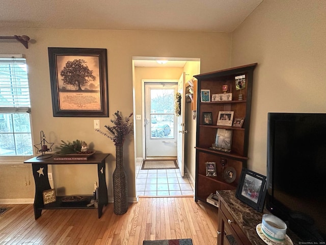 entrance foyer featuring light wood-style flooring and baseboards