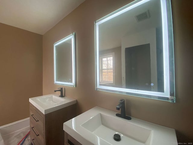 bathroom with visible vents and vanity