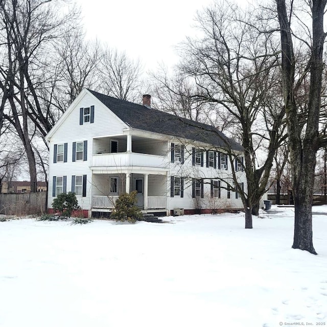 view of front of house featuring covered porch and a chimney