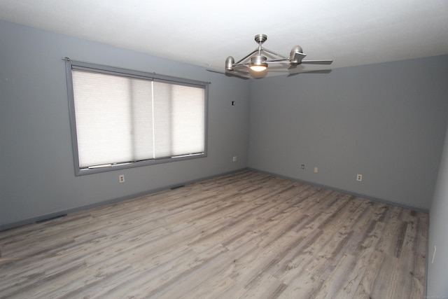 unfurnished room featuring light wood-type flooring and visible vents