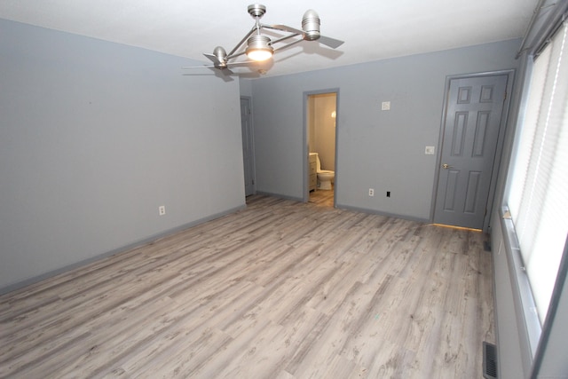 unfurnished room featuring light wood-type flooring, visible vents, and a ceiling fan