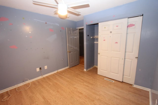 unfurnished bedroom with ceiling fan, light wood finished floors, visible vents, and baseboards