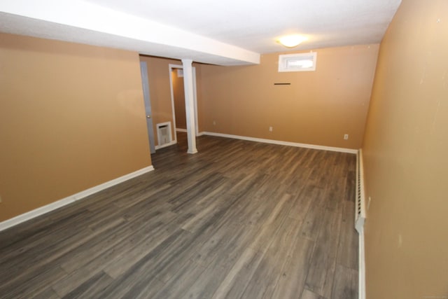 basement with dark wood finished floors and baseboards