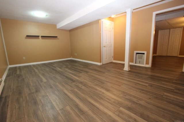 empty room with dark wood finished floors and baseboards