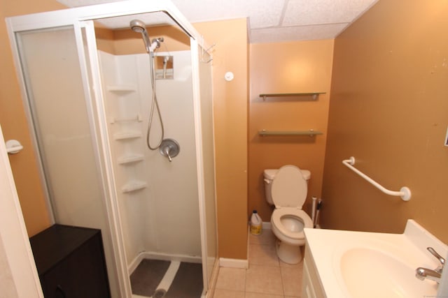 full bathroom with toilet, a stall shower, vanity, tile patterned flooring, and baseboards