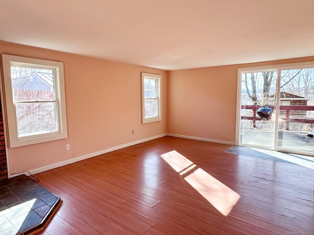 empty room featuring wood finished floors and baseboards