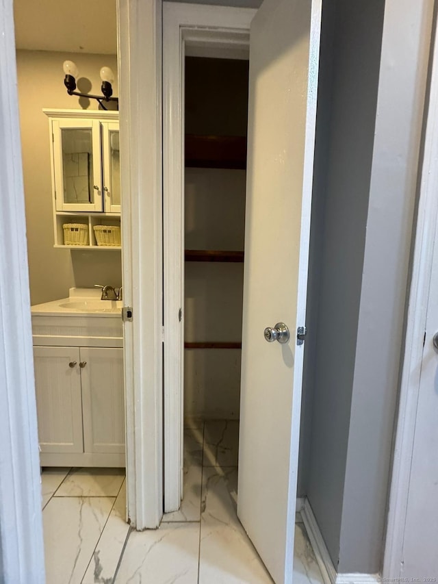 bathroom featuring marble finish floor and vanity