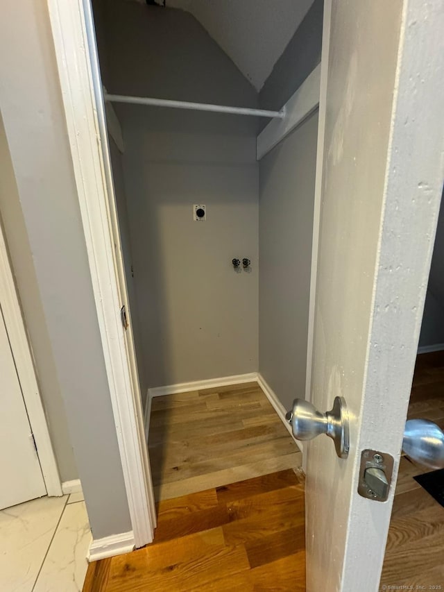 washroom featuring laundry area, baseboards, electric dryer hookup, and wood finished floors