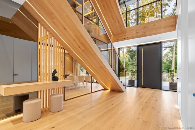 457 Field Point Rd, Greenwich, CT 06830 - foyer entrance featuring stairs, a wall of windows, and wood finished floors