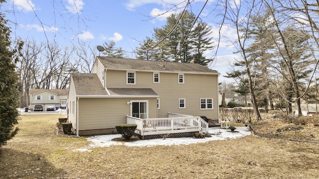 back of house featuring a deck and a chimney