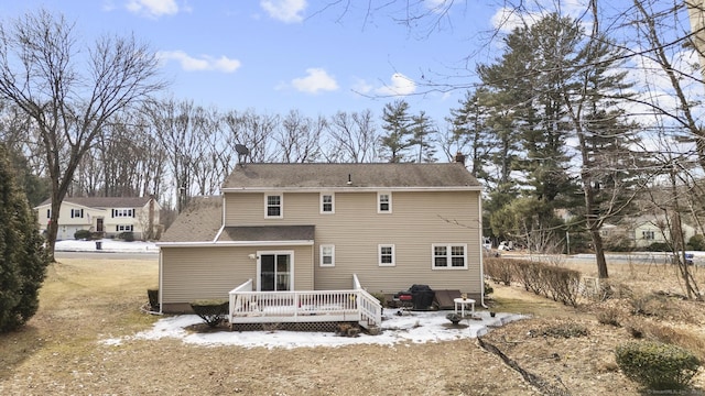 rear view of house featuring a deck