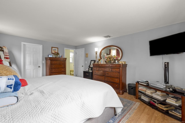 bedroom featuring light wood-style flooring and visible vents