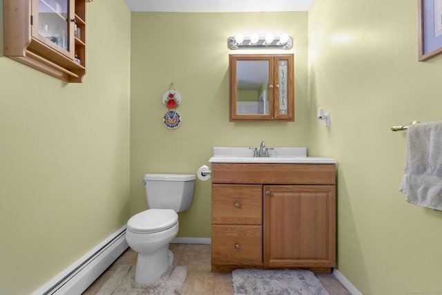 bathroom featuring baseboards, toilet, vanity, and baseboard heating