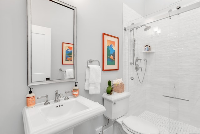 full bathroom featuring a stall shower, a sink, and toilet