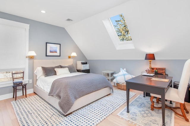 bedroom with vaulted ceiling with skylight, recessed lighting, visible vents, baseboards, and light wood-type flooring