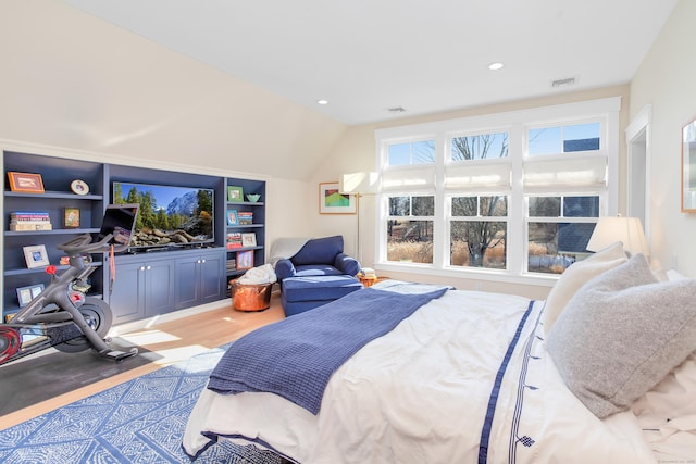 bedroom with lofted ceiling, light wood-style flooring, visible vents, and recessed lighting