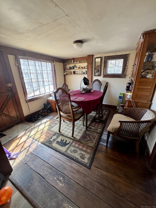 dining area with hardwood / wood-style flooring and baseboards