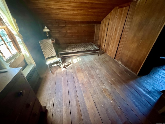 interior space with vaulted ceiling, hardwood / wood-style floors, and wooden ceiling