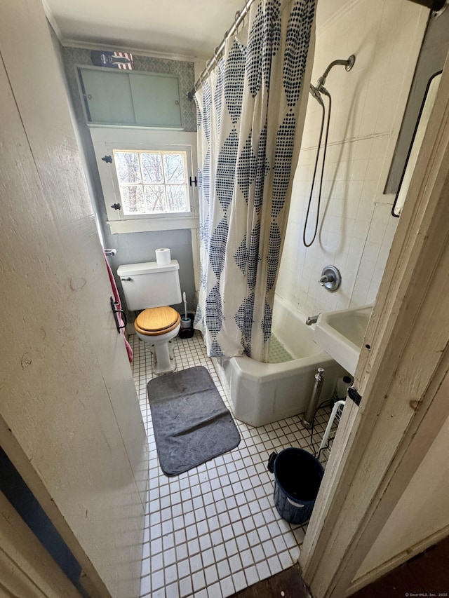 bathroom featuring tile patterned flooring, shower / tub combo, and toilet