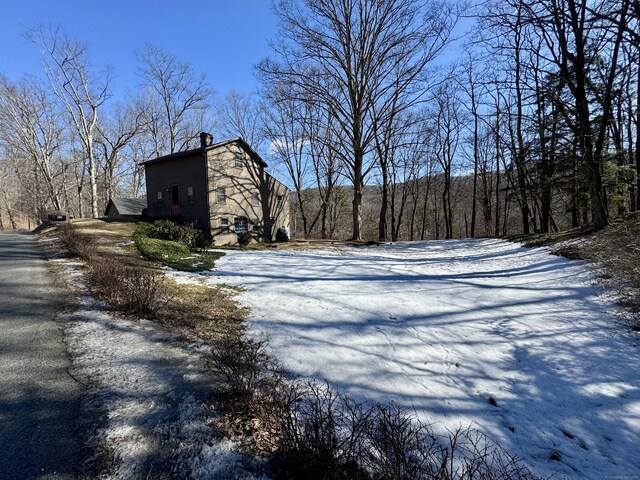 exterior space featuring driveway and a chimney