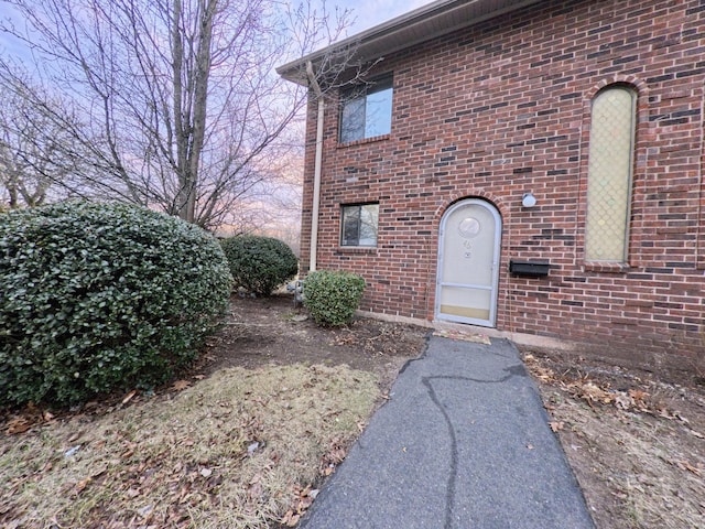 property entrance featuring brick siding