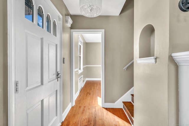 entrance foyer featuring light wood-style flooring, stairs, baseboards, and visible vents