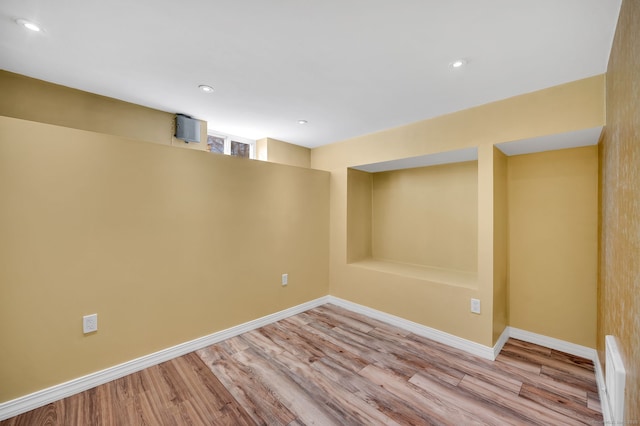 below grade area with recessed lighting, baseboards, and wood finished floors