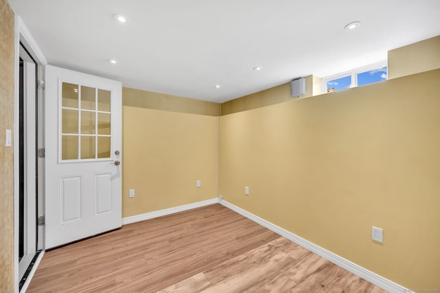 unfurnished room featuring baseboards, light wood finished floors, and recessed lighting