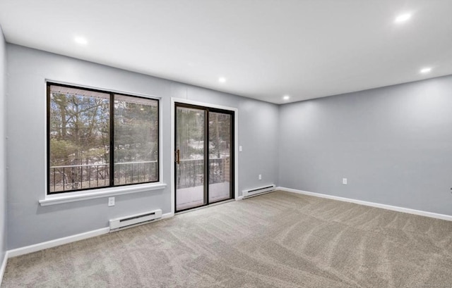 carpeted spare room with a baseboard heating unit, recessed lighting, and baseboards