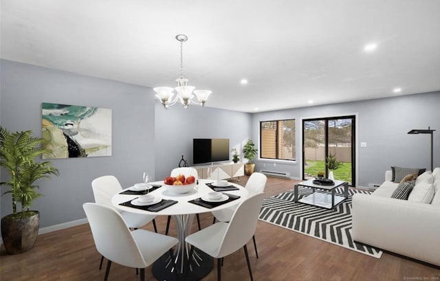 dining space featuring baseboard heating, wood finished floors, and recessed lighting