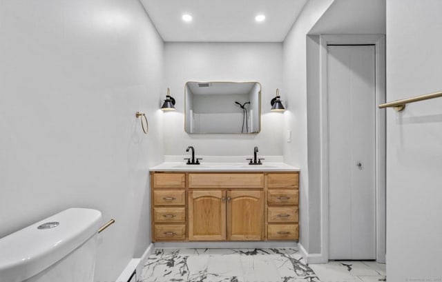 full bath featuring marble finish floor, a sink, and toilet