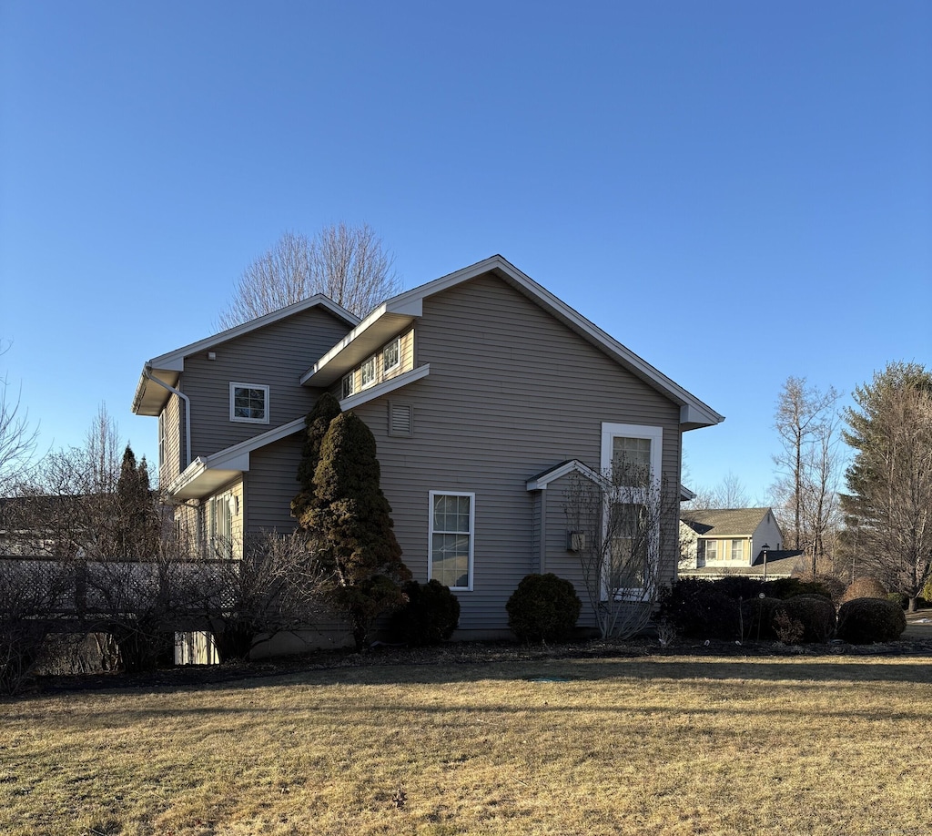 view of property exterior with a yard