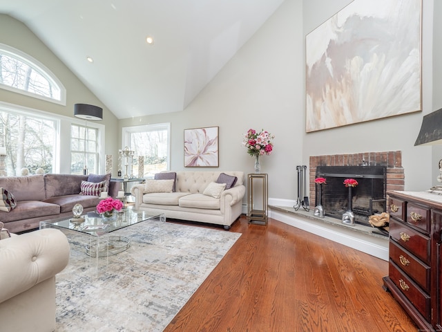 157 N Ave, Westport, CT 06880 - living area featuring plenty of natural light, a fireplace, high vaulted ceiling, and wood finished floors
