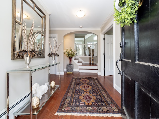 157 N Ave, Westport, CT 06880 - entrance foyer with a baseboard radiator, arched walkways, wood finished floors, and crown molding