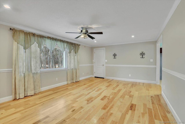 spare room featuring ornamental molding, ceiling fan, baseboards, and wood finished floors