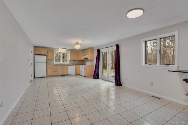 kitchen with light tile patterned floors, white appliances, visible vents, light countertops, and light brown cabinetry