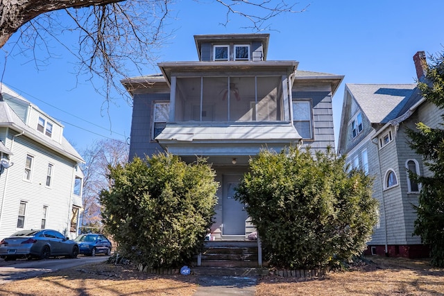 view of front of home with a sunroom