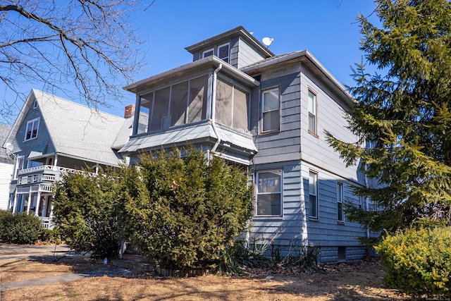 view of property exterior featuring a sunroom