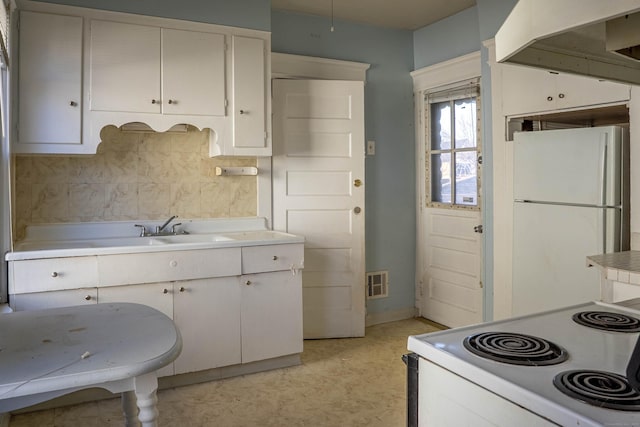 kitchen featuring light countertops, visible vents, a sink, white appliances, and under cabinet range hood