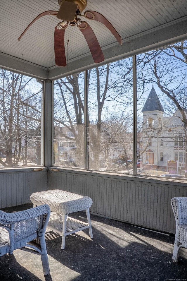 sunroom featuring ceiling fan and a healthy amount of sunlight