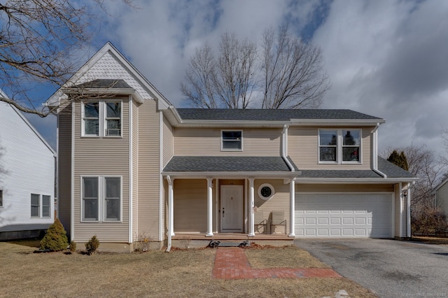 view of front of home with a garage, aphalt driveway, covered porch, and a shingled roof