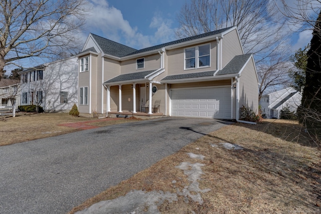 view of front of house featuring driveway, a garage, and roof with shingles