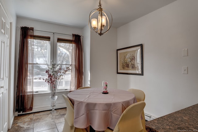 dining area featuring a baseboard radiator and a chandelier